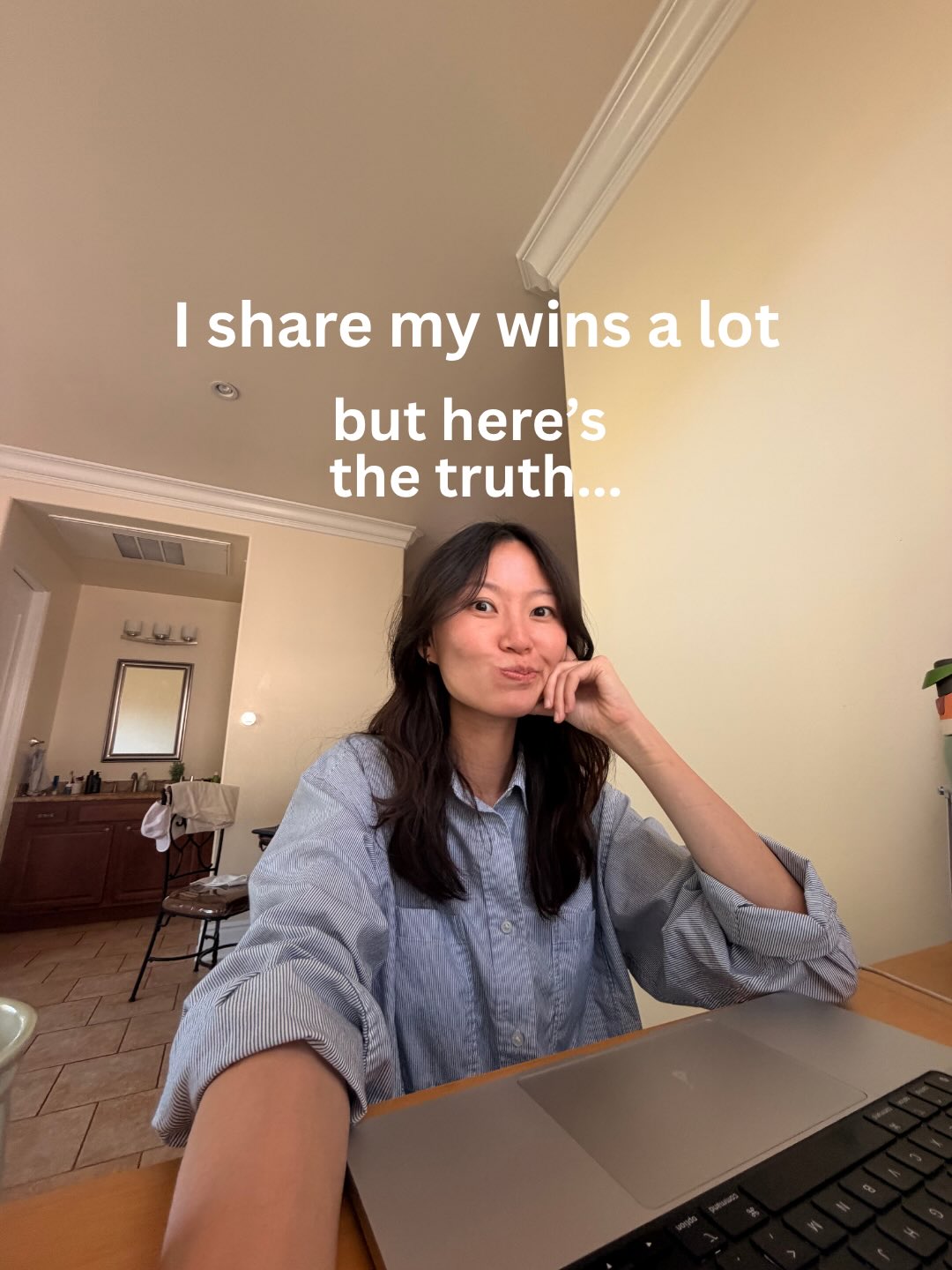 Melanie at her desk, chin on her hand